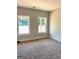Bedroom featuring neutral colored carpet and two windows providing ample natural light at 1705 Lake Dow Rd, Mcdonough, GA 30252