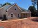 Angle view of new construction featuring a gray brick exterior and two car side entry garage at 1705 Lake Dow Rd, Mcdonough, GA 30252