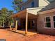 The exterior patio features stained wood beams and a brick house with light tan siding at 1705 Lake Dow Rd, Mcdonough, GA 30252