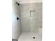 Shower featuring gray tiled walls, seat and niche at 1705 Lake Dow Rd, Mcdonough, GA 30252
