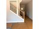 Staircase featuring stained wood with black wrought iron spindles at 1705 Lake Dow Rd, Mcdonough, GA 30252