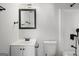 Bathroom boasts black fixtures, vanity, toilet, and shower with a tiled wall at 5180 Ash St, Forest Park, GA 30297