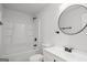 Bathroom featuring tub, vanity and round mirror at 5180 Ash St, Forest Park, GA 30297