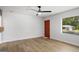 Bright, spacious bedroom with modern ceiling fan, large windows, and sleek flooring at 5180 Ash St, Forest Park, GA 30297