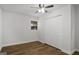 A simple bedroom with a ceiling fan, closet, and laminate flooring at 5180 Ash St, Forest Park, GA 30297