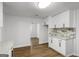 Bright kitchen area featuring white cabinets, marble backsplash, granite counters, and an open floor plan at 5180 Ash St, Forest Park, GA 30297