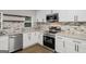 Beautifully updated kitchen with stainless steel appliances and granite countertops at 5180 Ash St, Forest Park, GA 30297