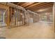 Exposed basement framing with ductwork awaiting transformation and finishing at 115 Edgewood Pkwy, Fayetteville, GA 30215