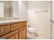 Bathroom with tile floor, wood vanity with stone countertop, and large mirror at 115 Edgewood Pkwy, Fayetteville, GA 30215