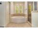 A clean, neutral-toned bathroom with a tub and separate shower at 115 Edgewood Pkwy, Fayetteville, GA 30215