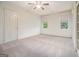 Bedroom featuring carpet floors, two windows with blinds, base molding, and closet at 115 Edgewood Pkwy, Fayetteville, GA 30215