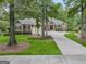Beautiful home with lush landscaping, a circular driveway, and mature trees at 115 Edgewood Pkwy, Fayetteville, GA 30215