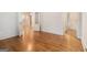Hallway features hardwood flooring, fresh paint, and neutral wall colors at 115 Edgewood Pkwy, Fayetteville, GA 30215