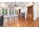 Bright living room with a stone fireplace, custom built-ins and hardwood floors at 115 Edgewood Pkwy, Fayetteville, GA 30215