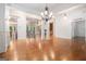 Open-concept living space with hardwood floors and elegant chandelier at 115 Edgewood Pkwy, Fayetteville, GA 30215