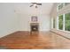 Living room features hardwood floors, a stone fireplace, and large windows for natural light at 115 Edgewood Pkwy, Fayetteville, GA 30215