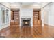 Cozy living room with a stone fireplace, custom built-ins, and hardwood floors at 115 Edgewood Pkwy, Fayetteville, GA 30215