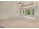 Large bedroom features neutral carpet, a tray ceiling, and a large window bay at 115 Edgewood Pkwy, Fayetteville, GA 30215