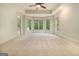 Large bedroom features neutral carpet, a tray ceiling, and three large windows at 115 Edgewood Pkwy, Fayetteville, GA 30215