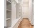 Mudroom features built-in shelving, hooks, and a bench with hardwood floors in hallway at 115 Edgewood Pkwy, Fayetteville, GA 30215