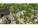 Serene aerial view of neighborhood homes with large lots surrounded by lush trees and a quiet pond, adding to the appeal at 3007 Brush Arbor Xing, Mcdonough, GA 30252