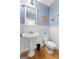Charming powder room with a pedestal sink, wainscoting, and light blue walls at 3007 Brush Arbor Xing, Mcdonough, GA 30252
