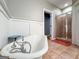 Bright bathroom featuring a stand alone tub, beadboard paneling, and a separate shower at 3007 Brush Arbor Xing, Mcdonough, GA 30252