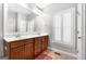 Bathroom with a double sink vanity with framed mirror and white shuttered windows at 3007 Brush Arbor Xing, Mcdonough, GA 30252