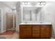 Bathroom featuring double sinks, a large mirror, and a tiled shower with a glass door at 3007 Brush Arbor Xing, Mcdonough, GA 30252