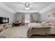 Bright bedroom featuring a ceiling fan, a sitting area, and a cozy carpet at 3007 Brush Arbor Xing, Mcdonough, GA 30252