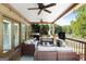 Relaxing covered deck with comfortable seating and a view of the lake at 3007 Brush Arbor Xing, Mcdonough, GA 30252