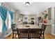 Dining area with a large wood table, seating for six and views into the kitchen and living spaces at 3007 Brush Arbor Xing, Mcdonough, GA 30252
