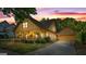 Charming home boasts a covered front porch with inviting string lights and manicured landscaping at 3007 Brush Arbor Xing, Mcdonough, GA 30252