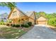 Beautifully landscaped home with a spacious driveway leading to an attached garage and inviting covered porch at 3007 Brush Arbor Xing, Mcdonough, GA 30252