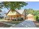 Attractive home featuring a large front porch, attached garage, and well-maintained landscaping on a sunny day at 3007 Brush Arbor Xing, Mcdonough, GA 30252