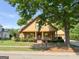 Home with a charming front porch, lush greenery, and a beautifully landscaped yard in a peaceful neighborhood at 3007 Brush Arbor Xing, Mcdonough, GA 30252