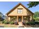 Inviting home exterior featuring a cozy front porch with hanging plants, brick accents, and manicured landscaping at 3007 Brush Arbor Xing, Mcdonough, GA 30252
