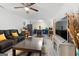 Living room featuring open kitchen, modern television, and dark comfortable seating at 3007 Brush Arbor Xing, Mcdonough, GA 30252