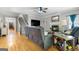 Open concept living room with hardwood floors, a fireplace, and adjacent staircase at 3007 Brush Arbor Xing, Mcdonough, GA 30252