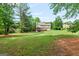 Expansive backyard featuring lush greenery and mature trees, perfect for outdoor activities and relaxation at 220 Drumcliff Ct, Tyrone, GA 30290