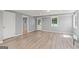 Open basement with wood floors, natural light, and multiple entryways at 220 Drumcliff Ct, Tyrone, GA 30290