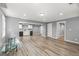 Spacious basement including plank floors and a kitchenette with white cabinetry at 220 Drumcliff Ct, Tyrone, GA 30290