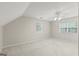 Angled bedroom featuring neutral carpeting, a ceiling fan, and double windows at 220 Drumcliff Ct, Tyrone, GA 30290