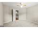 Bedroom featuring carpet, a ceiling fan, and a doorway leading to the hallway at 220 Drumcliff Ct, Tyrone, GA 30290