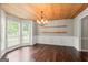 Bright dining room with hardwood floors, a wooden ceiling, white wainscoting, and large windows at 220 Drumcliff Ct, Tyrone, GA 30290