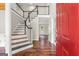Inviting foyer with hardwood floors, staircase, and glass-paneled door leading to another room at 220 Drumcliff Ct, Tyrone, GA 30290