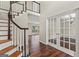 Open foyer with hardwood floors, a staircase, and french doors leading into another room at 220 Drumcliff Ct, Tyrone, GA 30290