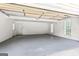 Bright and clean two-car garage with white walls, a gray floor, and natural light at 220 Drumcliff Ct, Tyrone, GA 30290