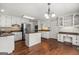 Bright kitchen features stainless appliances, white cabinets, and island at 220 Drumcliff Ct, Tyrone, GA 30290
