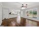 Open concept living area features hardwood floors, ceiling fan, and large windows at 220 Drumcliff Ct, Tyrone, GA 30290